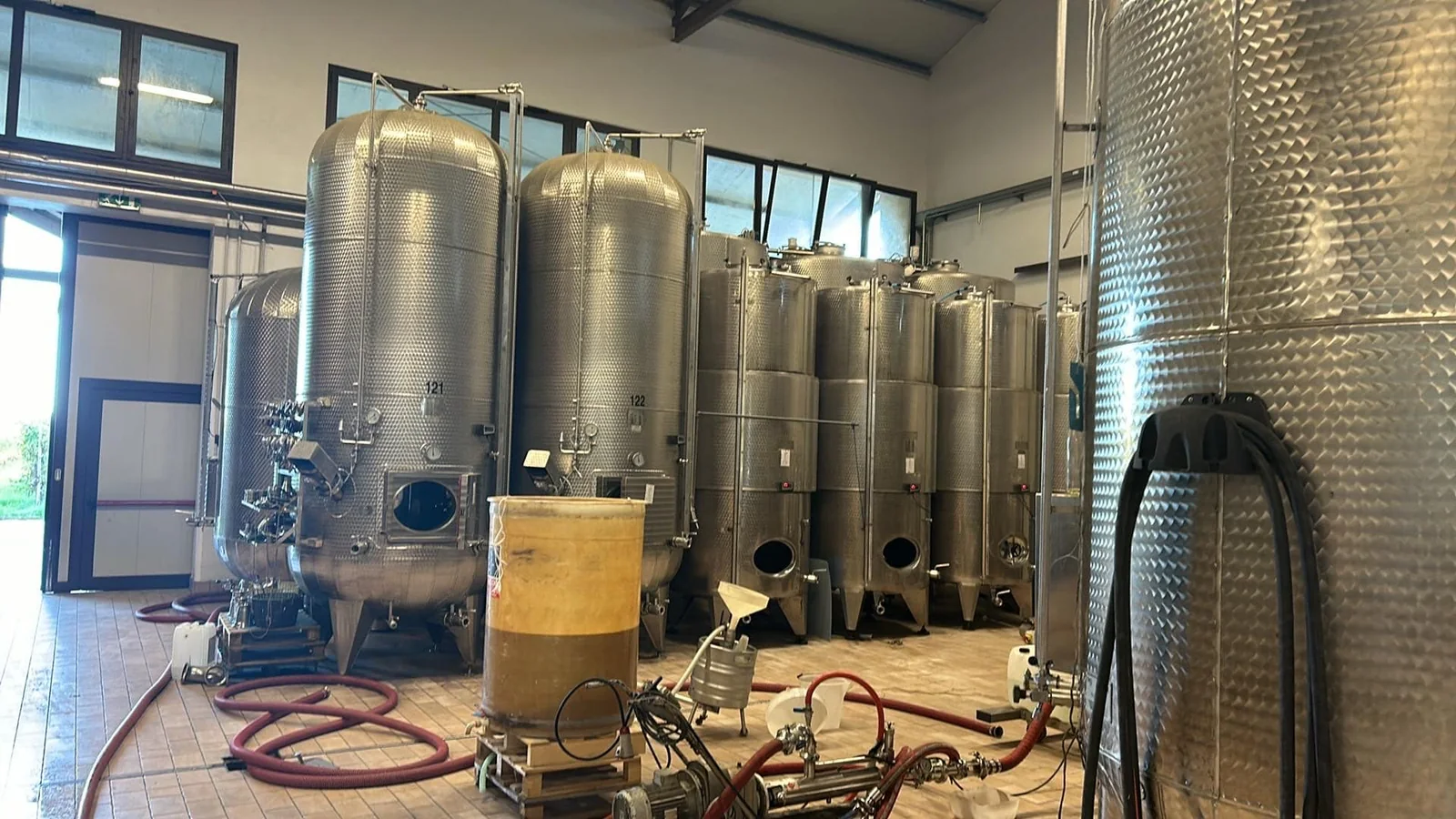 Stainless-steel fermentation and winemaking tanks inside the Famiglia Boron winery